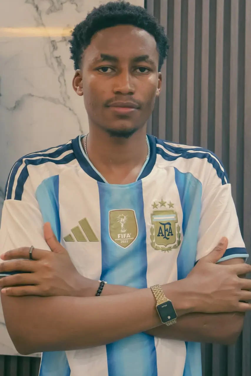 The Argentina supporter, arms crossed in the champions’ stripes, unsmiling and certain