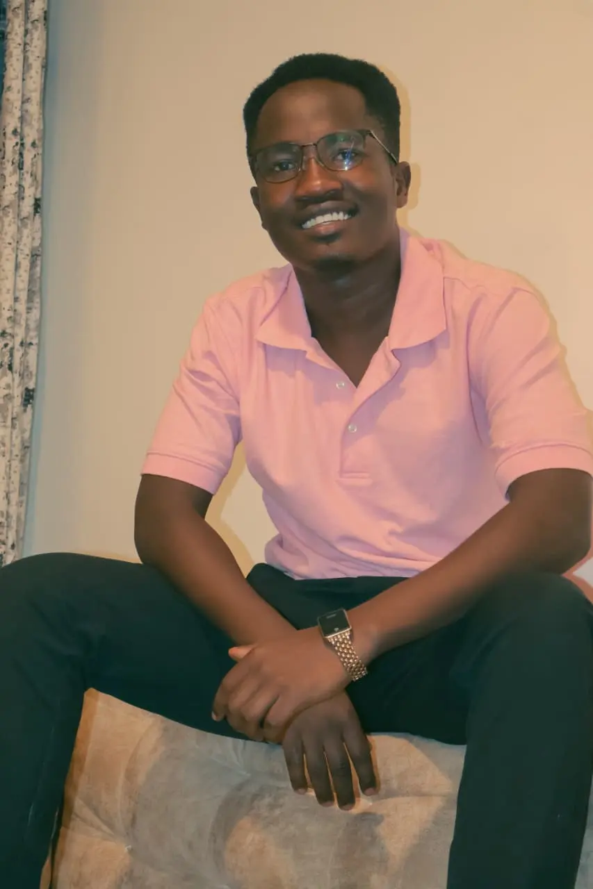 Ian Asena, seated and smiling warmly — the person who'll answer your message